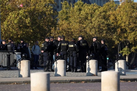A dozen police officers stood near the Arc de Triomphe.