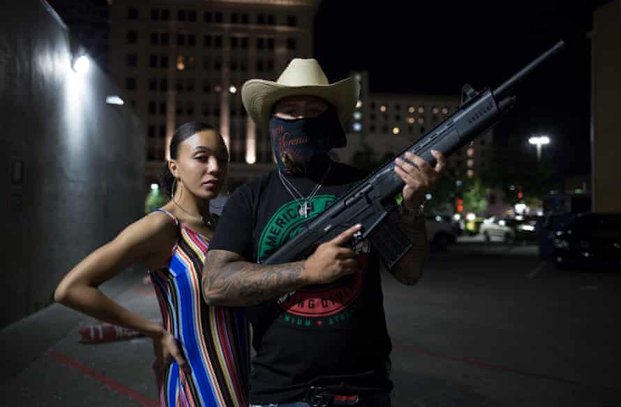 Young New Mexicans Celebrating Cinco de Mayo, 2019, Downtown Albuquerque. Two teenagers explain to me they must arm themselves amidst a rising homicide rate in the city.