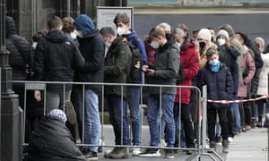People with mandatory face masks line up to enter the Cathedral in Cologne as health minister Karl Lauterbach announces Germany will study how reliable rapid antigen tests are in detecting the Omicron variant of Covid-19.