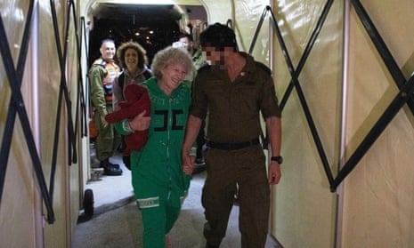 Ruti Munder walks with an Israeli soldier shortly after her arrival in Israel on Friday.