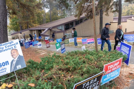 people walk among many political signs