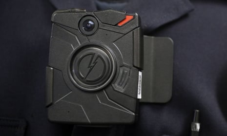 A police officer demonstrates the use of a body camera.
