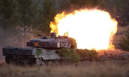A Leopard 2 main battle tank of the German armed forces Bundeswehr shoots during a visit by the German Chancellor of the troops during a training exercise at the military ground in Ostenholz, northern Germany, on 17 October 2022.