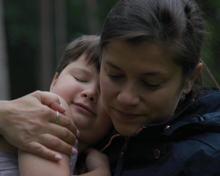 A woman hugs seven-year-old Sasha