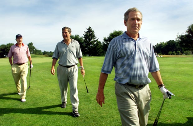 George W Bush, right, with his brother and father in 2001.