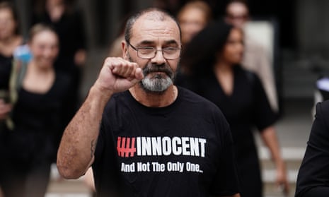 Andrew Malkinson raises a fist signifying victory, wearing a shirt that says: 'Innocent. And not the only one …'