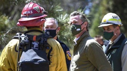 Governor Gavin Newsom talks with local and state fire officials while touring an area burned by last year’s Creek fire near Shaver Lake in Fresno county, California.