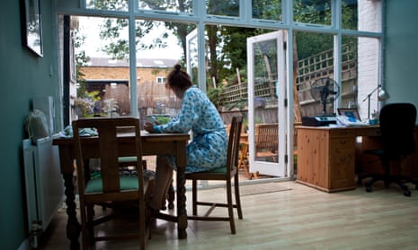 Woman seated at dining table in conservatory.