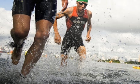 Britain’s Jonathan Brownlee, left, and Marco Van Der Stel, of the Netherlands, come out of the water in the mixed triathlon relay.