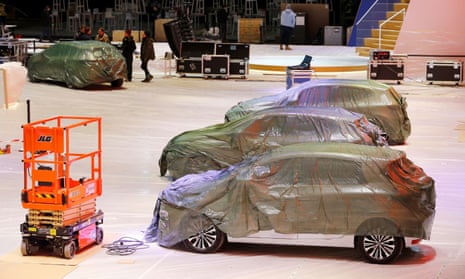 Covered cars are pictured at the Palexpo exhibition centre, which had been due to stage the Geneva motor show.