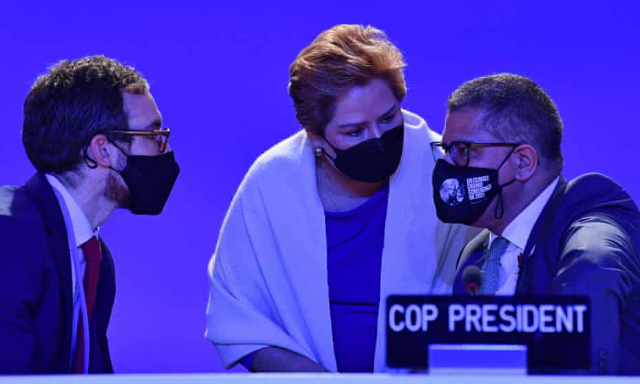 The Cop26 president Alok Sharma, right, and UNFCCC executive secretary, Patricia Espinosa, centre, talking at the climate conference.