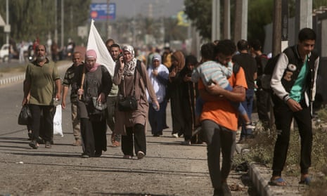 Palestinians carrying white flags flee Gaza City on Tuesday.