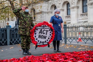 London, England. A veteran and a nurse lay a wreath at the Cenotaph on behalf of Extinction Rebellion, warning about the risk of future conflict resulting from the climate crisis. The wreath and a banner were removed by police