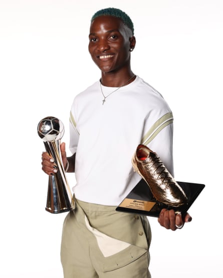 Temwa Chawinga of Kansas City Current poses with the Most Valuable Player and the Golden Boot awards.