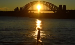 A woman walking past Sydney harbour bridge in Australia. NSW recorded 262 new locally acquired cases of Covid-19 in the past 24 hours