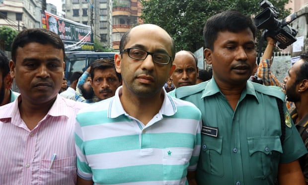 Bangladeshi police officers escort Hasnat Karim, centre, to a court appearance in Dhaka in August 2016.