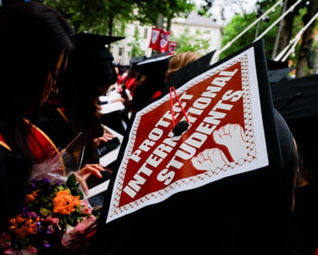 a graduation cap reads 'protect international students'