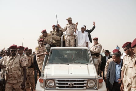 Mohamed Hamdan Dagalo waves a baton as he arrives for a rally in the village of Abraq, about 60km north-west of Khartoum