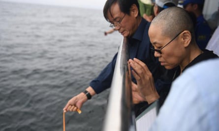 Liu Xia (front) was last seen in photos issued by Beijing as her husband’s ashes were scattered at sea off the coast of Dalian, Liaoning province.