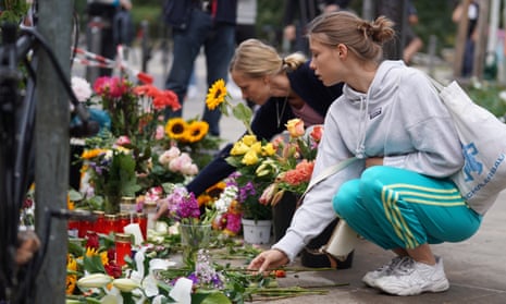 People lay flowers at the site of a car accident in Berlin, Germany.