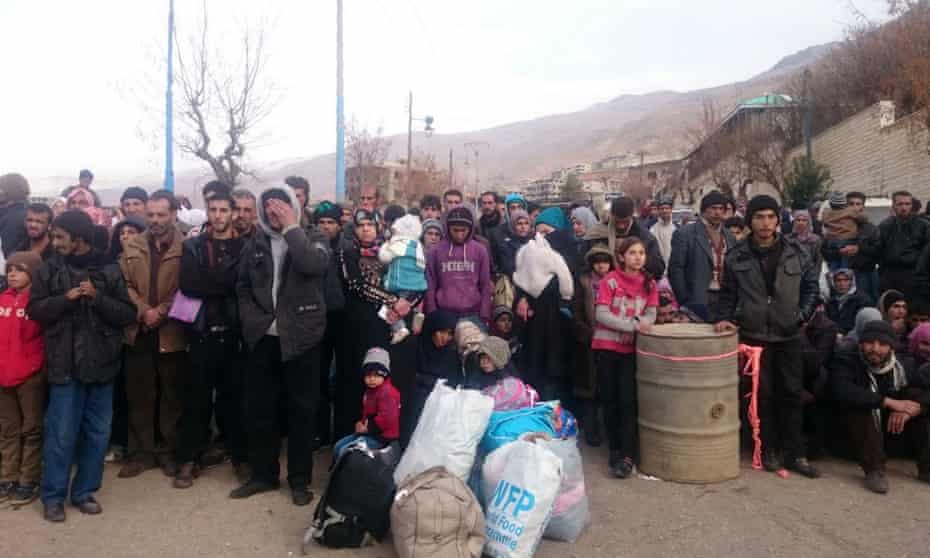 Syrians in the besieged town of Madaya waiting for the arrival of an aid convoy in January.