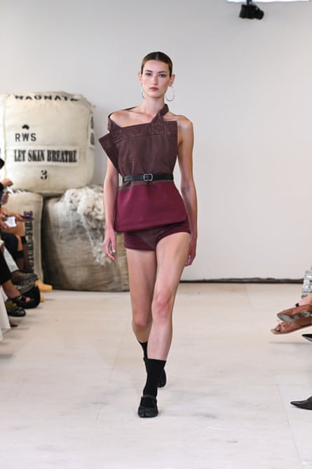 A model walks down the catwalk wearing an outfit by designer Nagnata
