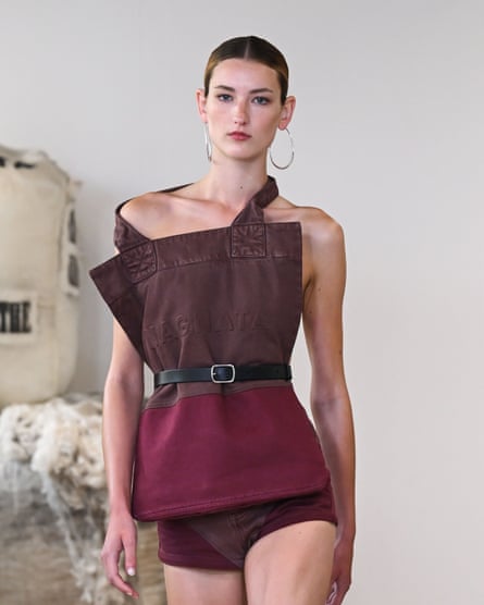 A model walks down the catwalk wearing an outfit by designer Nagnata