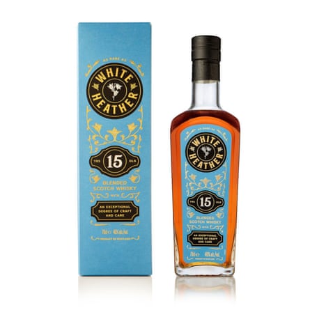 A bottle of White Heather 15 YO whisky next to its bright blue packaging.