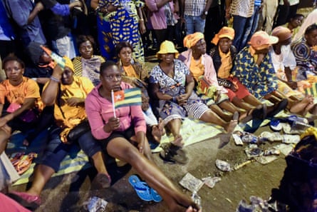 Anti-government protesters sit on a street in Lomé as they keep an all-night vigil to press for constitutional reform
