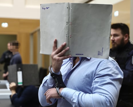 A Ukrainian defendant arrives before the court during his trial at the Higher Regional Court in Stuttgart, Germany.