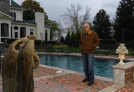 Puzder stands next to a swimming pool at his home in Franklin, Tennessee