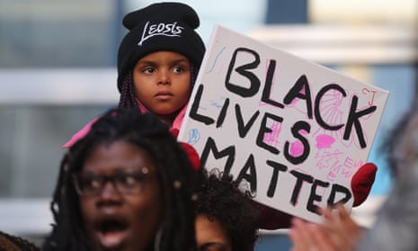 Attendees at a Black Lives Matter rally at Toronto police headquarters on 26 March. 