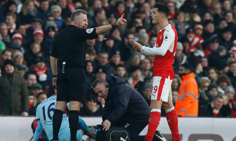 Granit Xhaka, right, is sent off by referee Jon Moss following a challenge on Steven Defour during Arsenal’s 2-1 win against Burnley at the weekend