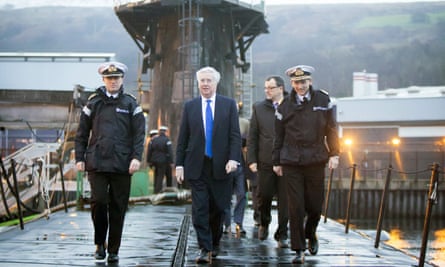 Michael Fallon, centre, aboard HMS Vigilant during a visit to the Royal Navy’s submarine base at Faslane.
