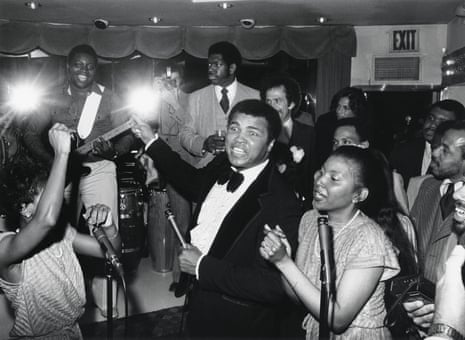 a man in tuxedo surrounded by crowd of people