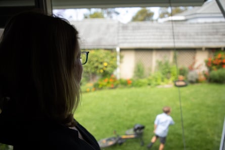 Jacqui looks out at her parents garden from the granny flat as her son returns home from school.