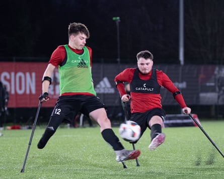 Rhyce Ramsden (right) flies into an attempted tackle on fellow England amputee player Nathan Fisher (left) during a training session.