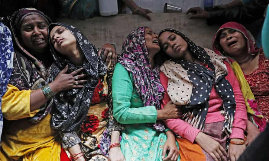 Relatives mourning Hashim Ali, who died after being wounded during the riots.