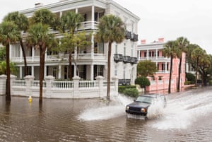 A car drives through floodwater along the Battery, in the historic district of Charleston, South Carolina
