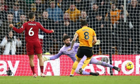 Ruben Neves of Wolverhampton Wanderers scores his sides third goal past Alisson.