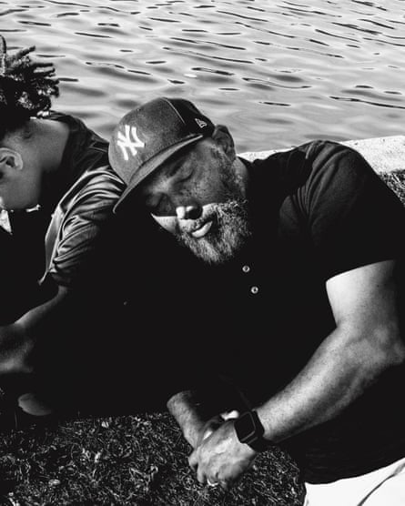 Panther cub Alprentice Davis closes his eyes and lays beside his daughter at Kissena Park, New York.