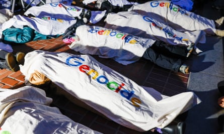 Protesters lie down in Google branded body bags.