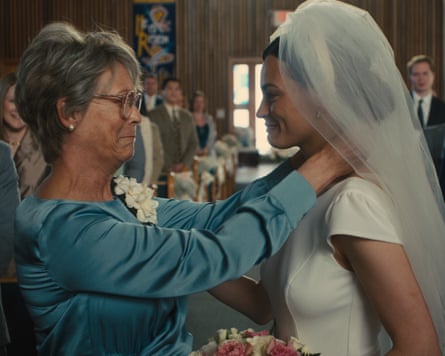 Jamie Lee Curtis looking at Emma Mackey, who is wearing a wedding dress