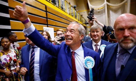 Nigel Farage accompanied by party officials and a minder giving a thumbs-up to unseen supporters