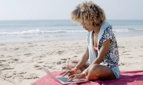 girl with a laptop on a beach