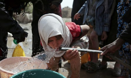 A girl drinks water from a well that is allegedly contaminated with cholera.