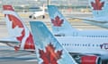 Air Canada planes on an airport tarmac.