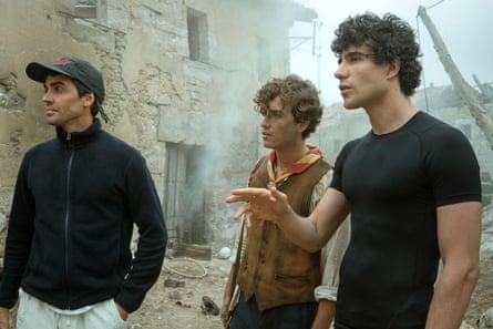 Directors Javier Ambrossi and Javier Calvo with Guitarricadelafuente on set amid ruins and smoke