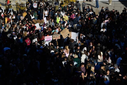 people hold signs outside