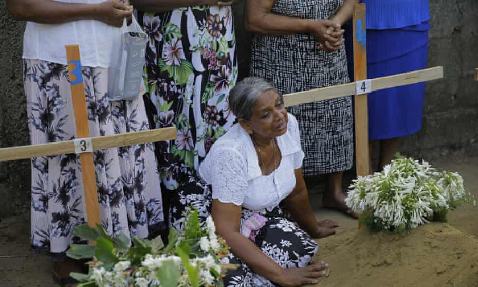A Sri Lankan woman sits next to the grave of a family member in Katuwapitiya village, Negombo.